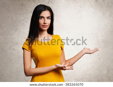 Beautiful young woman presenting something Royalty-Free Stock Photo #383265070