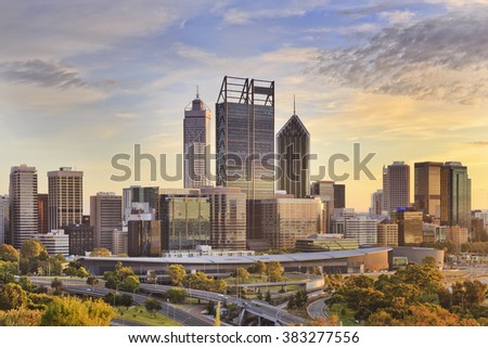 Perth city CBD towers close up view from lookout of Kings park at sunrise during gold sun light hour.  Royalty-Free Stock Photo #383277556