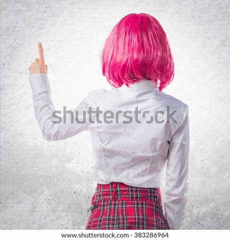Girl with pink hair pointing back
