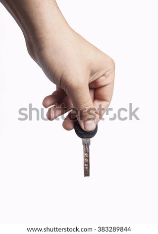 Hand holding old vintage silver key, isolated on white background ** Note: Soft Focus at 100%, best at smaller sizes