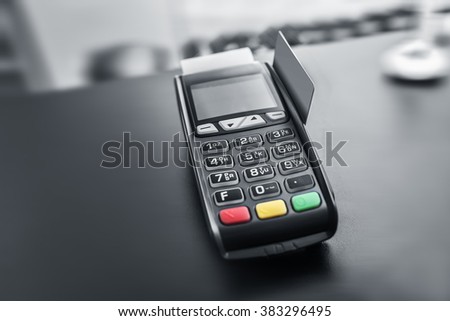 Bank terminal and payment card in the office interior.