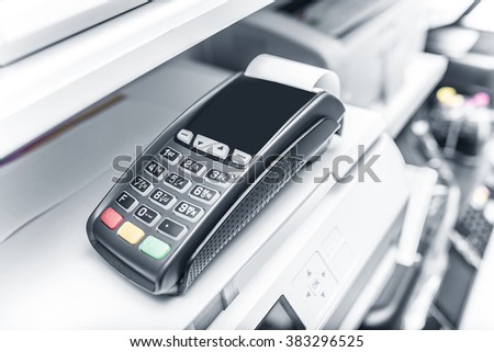 Bank terminal and payment card in the office interior.