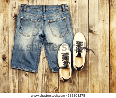 Set of travel items including jeans and sneakers. Planning of  overhead of essentials for vacation and travelling on holiday. Photo with retro filter effect.