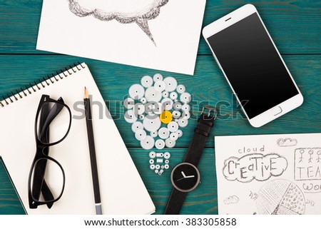 Business idea concept - bulb sign, phone, watch and notepad on the desk