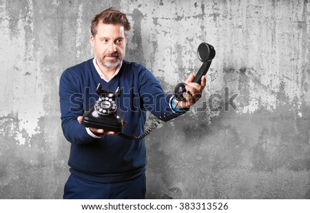 mature man offering a telephone