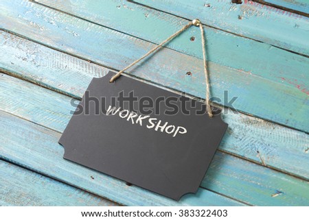 workshop chalk sign on blue wood background