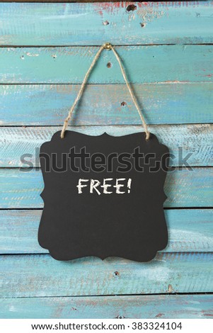 Free sign on blue wood background