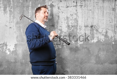 mature man with a golf club
