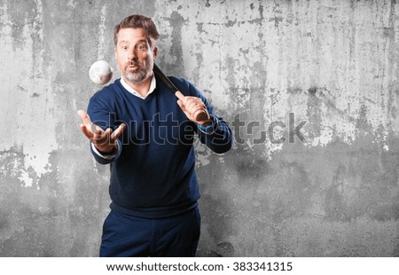 mature man playing baseball
