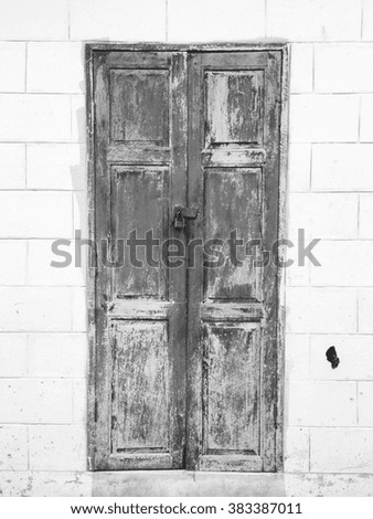 Old vintage wood doors and key rusty lock. black and white picture.