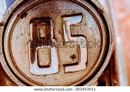 Old vintage car decoration chrome knob with number 85 close up image