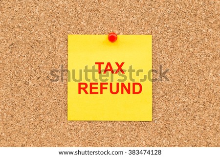Yellow blank note and written TAX Refund for reminder.