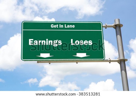 Green overhead road sign with the instruction to get in lane with a Earnings or Loses concept against a partly cloudy sky background.