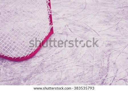 Ice hockey goal and the skate marks on the ice in Finland. Image includes a vintage effect.