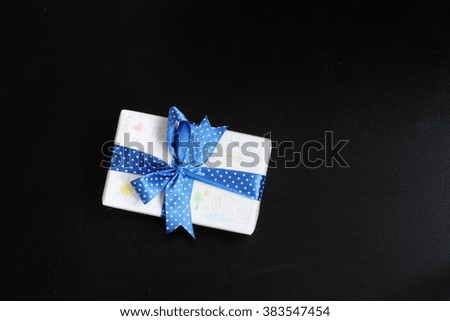 gift with blue ribbon and baby pictures/Children's holiday gift