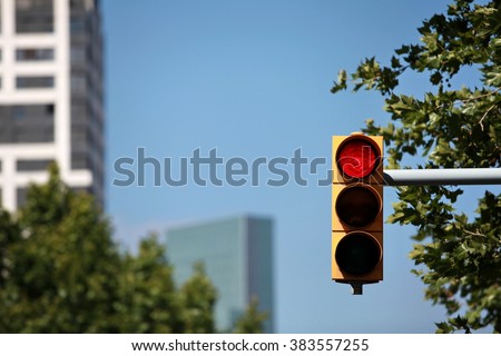 red  traffic light on the background of the skyscraper Royalty-Free Stock Photo #383557255