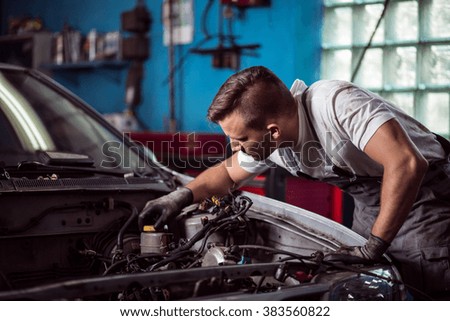 Picture of car mechanic repairing broken vehicle