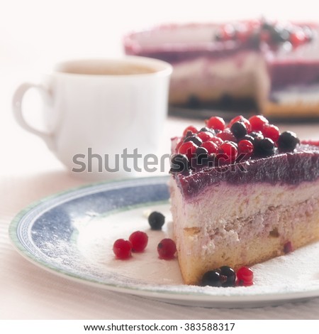 Piece of currant and gelatin dessert with cup of coffee, light vintage picture