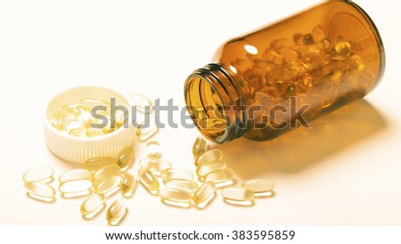 Fish oil capsule isolated on white.