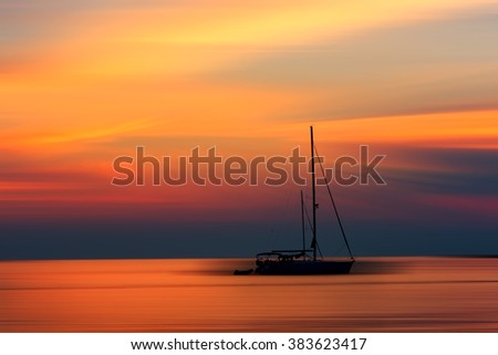 Beautiful sunset seascape - colorful sea background with a yacht