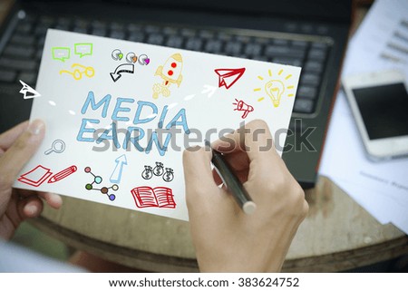 hand drawing MEDIA EARN concept on white notebook , business concept , business idea