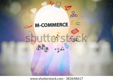 holding light bulb with M COMMERCE text ,business concept ,business idea