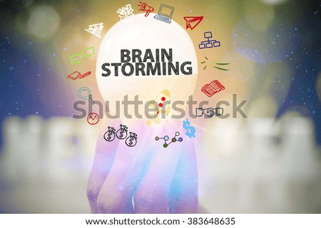 holding light bulb with BRAIN STORMING text ,business concept ,business idea