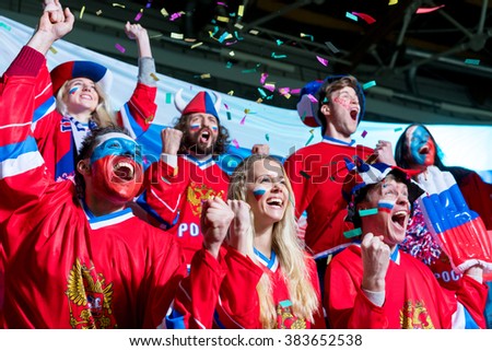 Young sports fans in stadium Royalty-Free Stock Photo #383652538