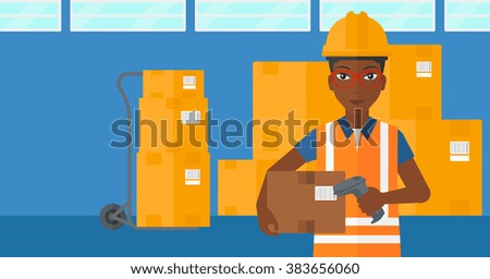 Worker checking barcode on box.
