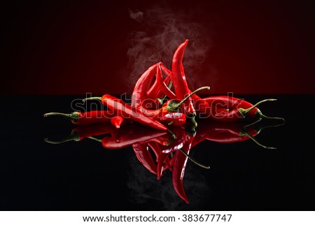 beam of red chilli pepper on black background Royalty-Free Stock Photo #383677747