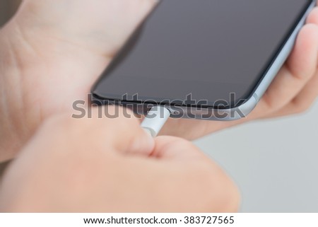 close up hand using usb cable connect to phone