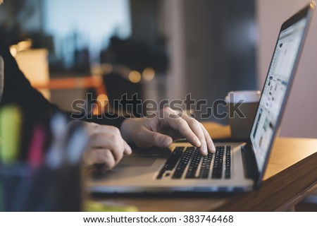 Close-up of male hands using laptop at office, man's hands typing on laptop keyboard in interior,, side view of businessman using computer in cafe