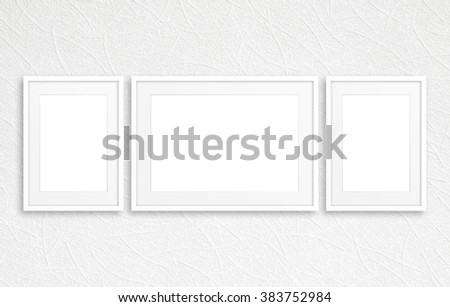 Three blank photo frames mockup on white textured wall
