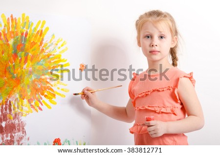 cute little girl draws a picture