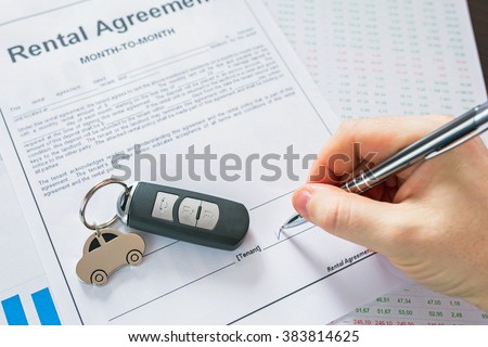 Rental agreement for a car with contract, pen and keys