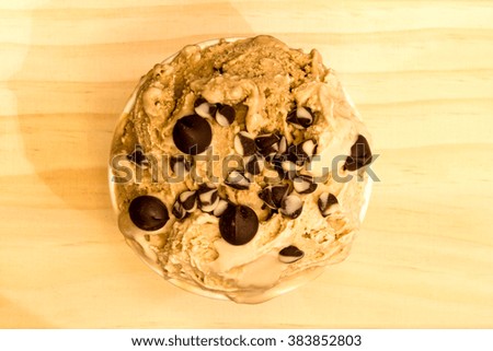 top view of coffee flavor icecream with topping with chocolate chips on the soft wooden background Royalty-Free Stock Photo #383852803