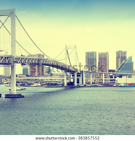 Tokyo, Japan - view of Rainbow Bridge from Odaiba island. Filtered retro style.