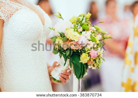 Wedding bouquet with peony, roses, orchids, and green leaves. Tenderness hand made accessory for bride