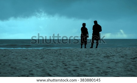 silhouette couple were relaxing on the beach