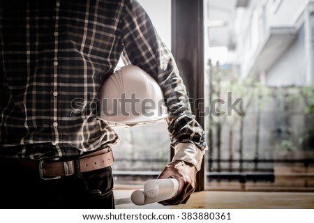 Smart Businessman holding construction helmet and blueprints in retro style. Royalty-Free Stock Photo #383880361