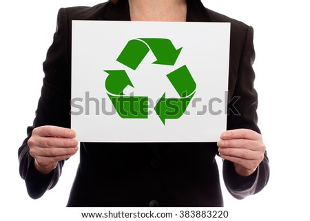 A woman in a business suit holding a piece of paper with a recycle symbol