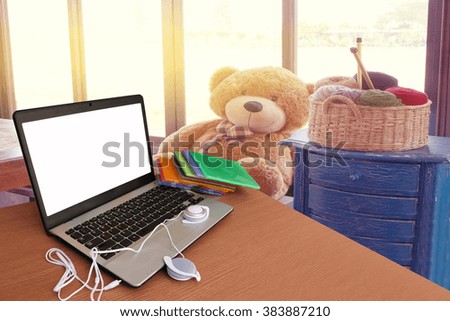 laptop and headphone with blur image of coffee shop