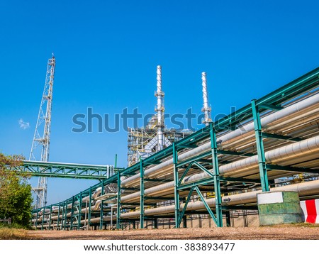 Power plant with liquid and chemical pipe rack with blue sky Royalty-Free Stock Photo #383893477