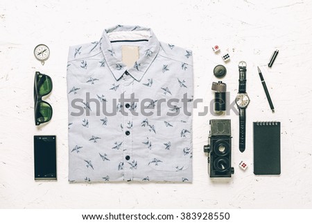 Men's casual outfits on wood board background, Essential vacation item for traveler