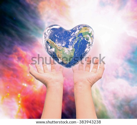 World in heart shape with over women human hands on blurred natural background: World Heart health day,Element of this image furnished by NASA