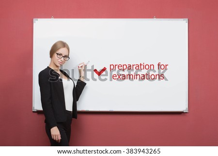girl writes preparation for examinations on a white board.  