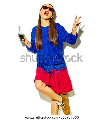 beautiful crazy smiling brunette woman girl in casual hipster summer colorful clothes with red lips isolated on white drinking soda from bottle with straw in sunglasses showing peace sign
