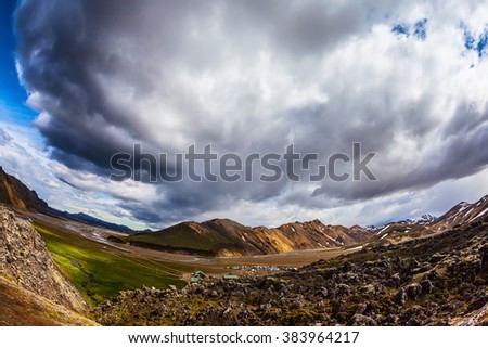  Travel to Iceland in July, volcanic summer tundra. Multi-colored rhyolite mountains - orange, yellow, green and blue. The picture was taken Fisheye lens