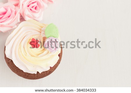 Fresh tasty cupcake on white wooden table. Food background. Beautiful eating. Sweet home concept.