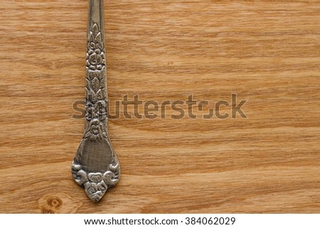 Antique Silver Spoon on Wooden Background